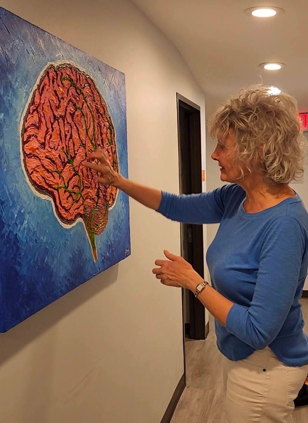 Dr. Blake explains the painting to patients